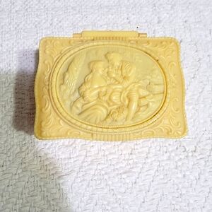 Antique makeup box with mirror and handheld mirror, and heart soap.